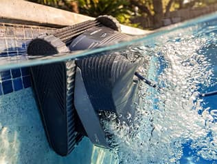Energy-efficient Dolphin robotic pool cleaner operating in a clear pool